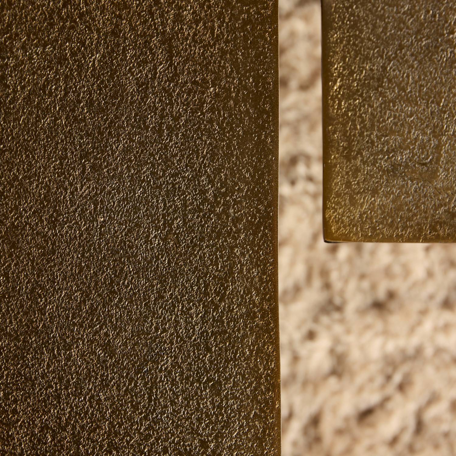 Robuste Kante des Metall Couchtisches in Bronze-Optik mit feiner Textur – Maragas