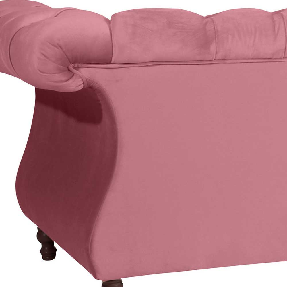 Seitliche Ansicht des rosa 2er Sofas mit eleganter geschwungener Form für das Wohnzimmer – Clewono
