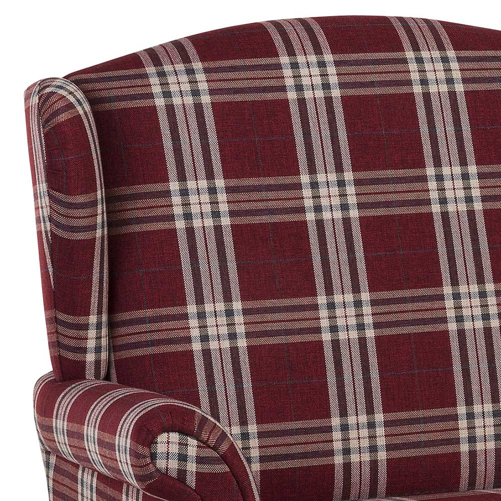 Detail des karierten Stoffbezugs und der geschwungenen Armlehne am roten Sofa – Matieu