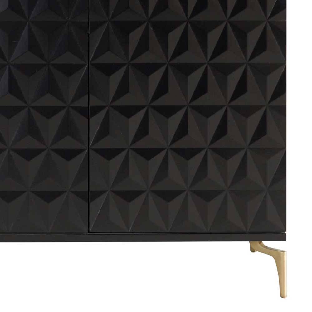 Unteres Detail der schwarzen Sideboard-Front mit geometrischer Struktur und goldenem Bein – Ardit