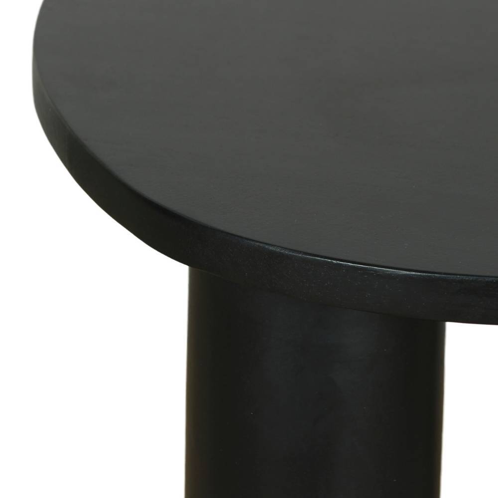 Detail der glatten schwarzen Tischplatte und des runden Tischbeins vom Couchtisch Dulacre